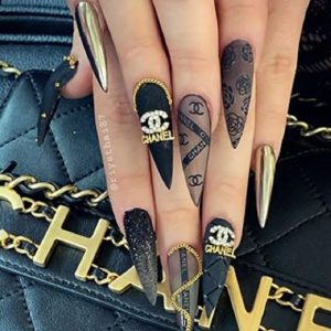 Silver Chanel nail art with charms